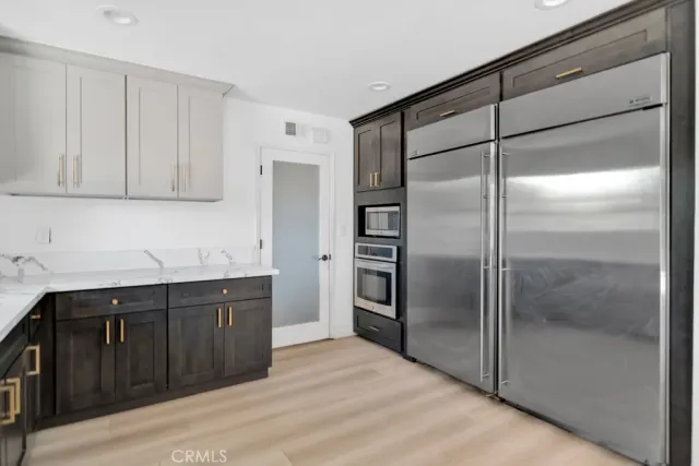 a kitchen with a refrigerator and a sink