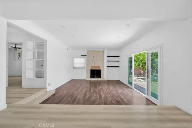 wooden floor in an empty room with a fireplace
