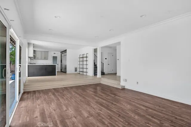 a view of a kitchen with a sink and a refrigerator
