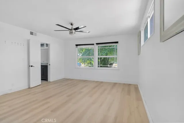 an empty room with windows and closet