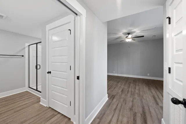 a view of a room with wooden floor