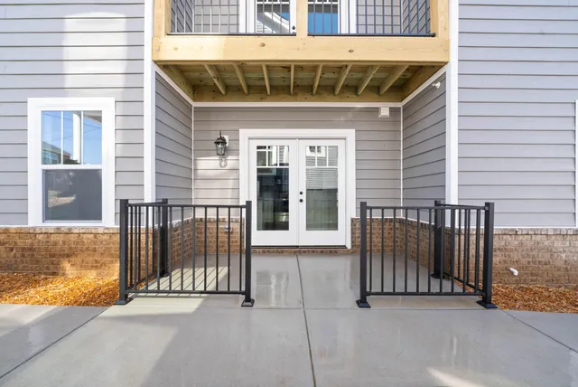 a view of a porch with a floor to ceiling window and wooden floor