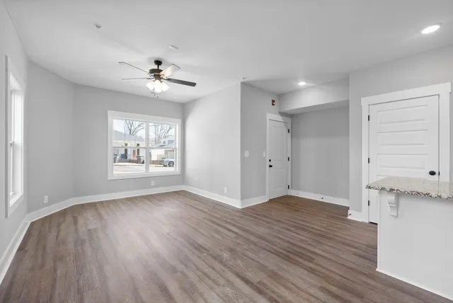 wooden floor in an empty room with a window