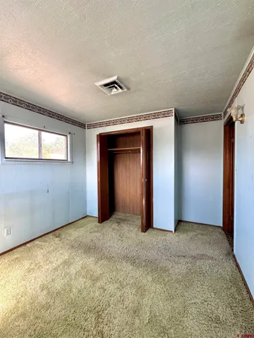 an empty room with a empty space and windows