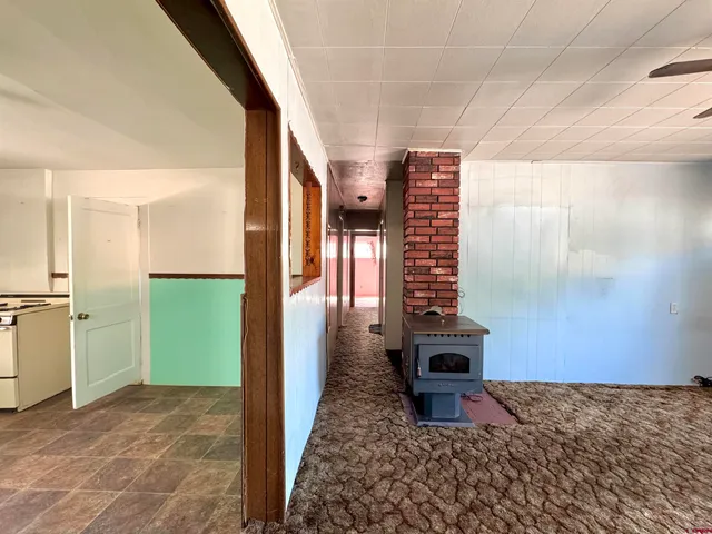 a view of a kitchen with refrigerator and window