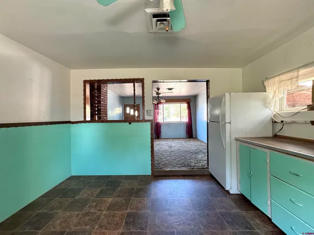 a kitchen with a refrigerator and a sink