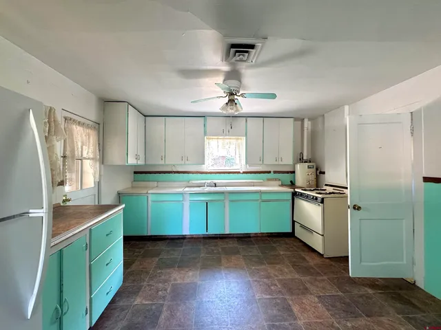 a kitchen with a refrigerator and a sink