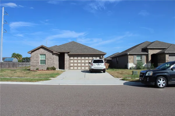 a car parked in front of a house with a yard