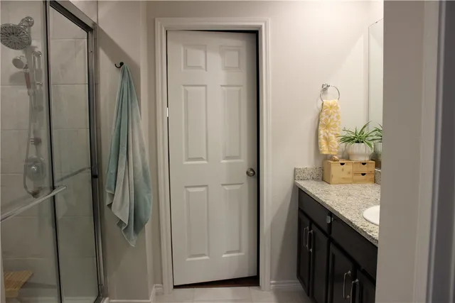 a bathroom with a granite countertop sink and a mirror