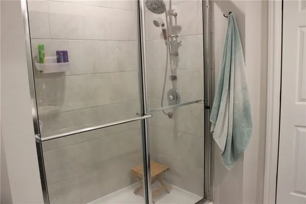 a bathroom with a glass shower door