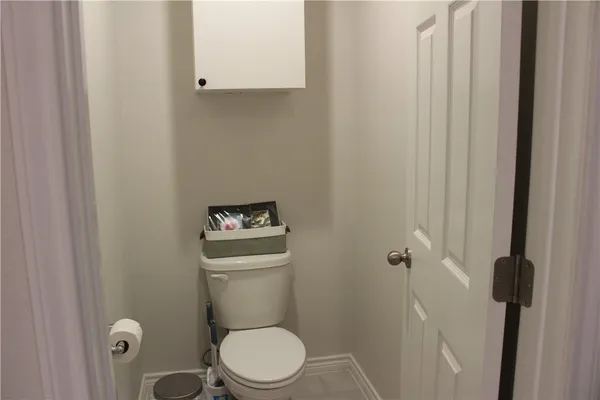 a white toilet sitting next to a shower