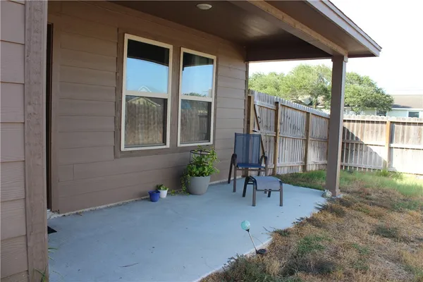 a view of a porch with furniture and garden