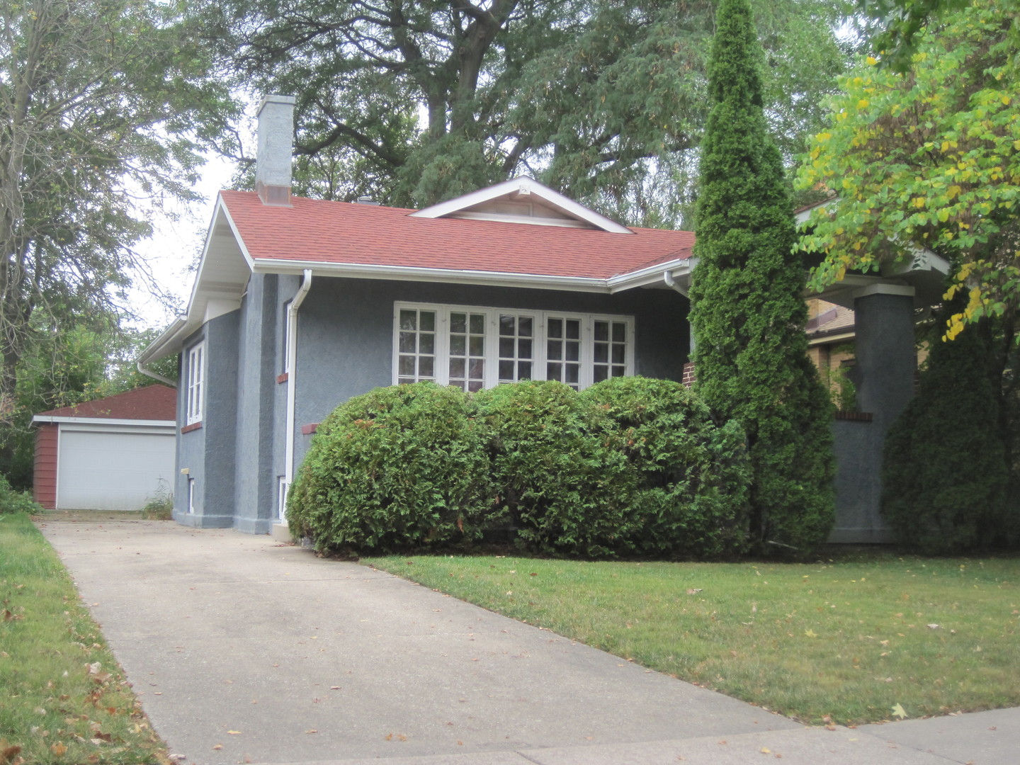 297 Olmsted Road Riverside, IL 60546 - Photo 1 of 15 a front view of a house with a garden
