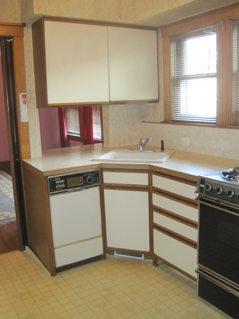 297 Olmsted Road Riverside, IL 60546 - Photo 10 of 15 a kitchen with stainless steel appliances a sink stove and a refrigerator