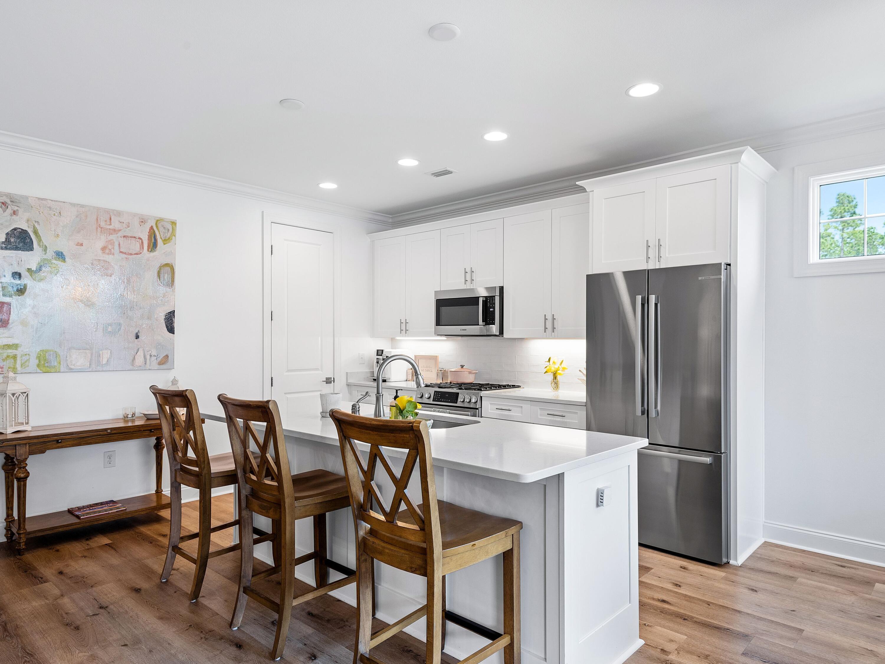 7 Cambium Ct Inlet Beach Inlet Beach, FL 32461 - Photo 17 of 50 a kitchen with stainless steel appliances a dining table chairs refrigerator and microwave
