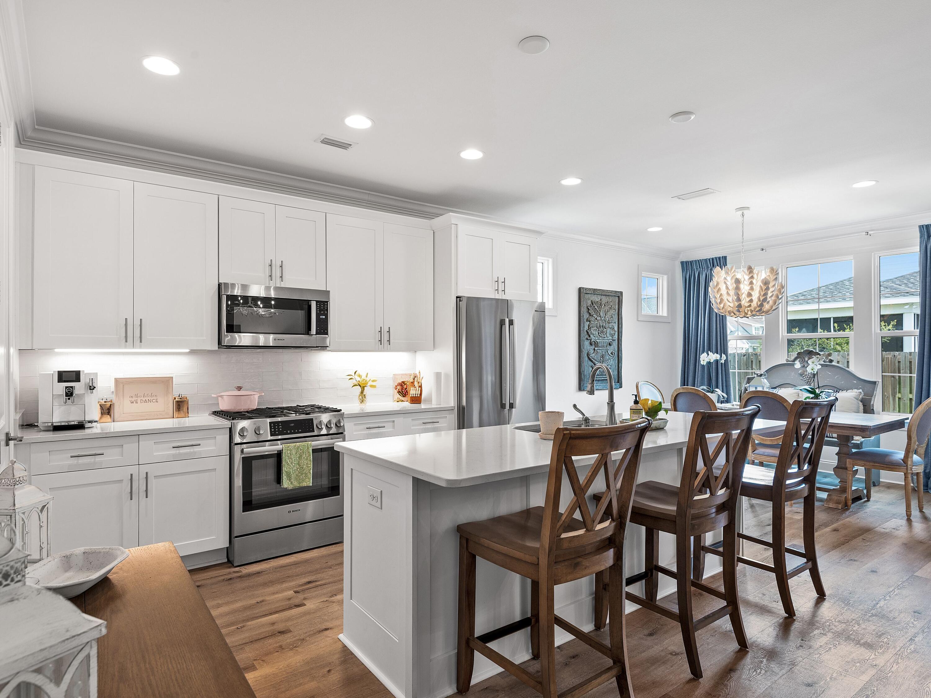 7 Cambium Ct Inlet Beach Inlet Beach, FL 32461 - Photo 2 of 50 a large kitchen with stainless steel appliances granite countertop a stove a sink a dining table and chairs