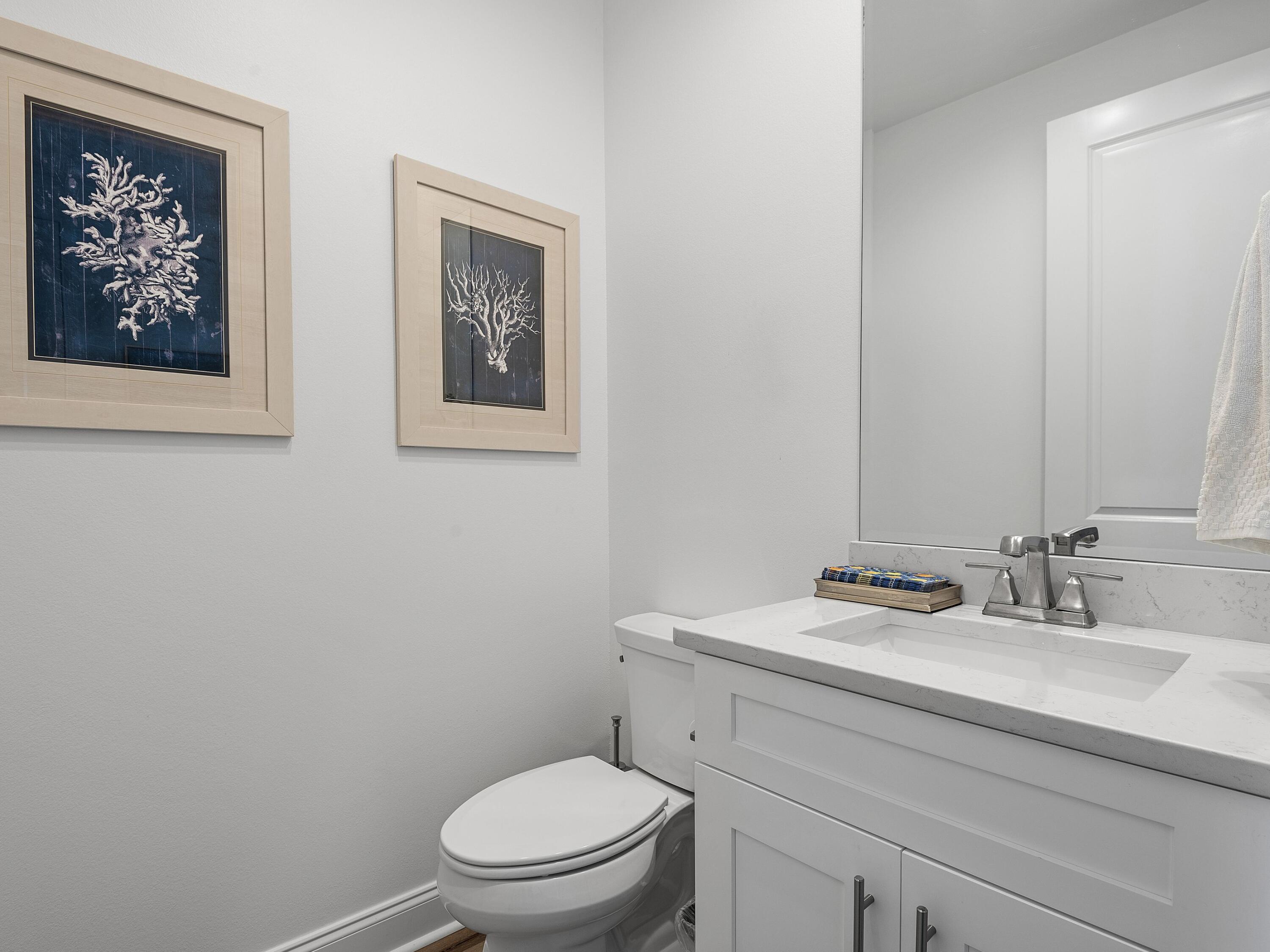7 Cambium Ct Inlet Beach Inlet Beach, FL 32461 - Photo 23 of 50 a bathroom with a toilet sink and mirror