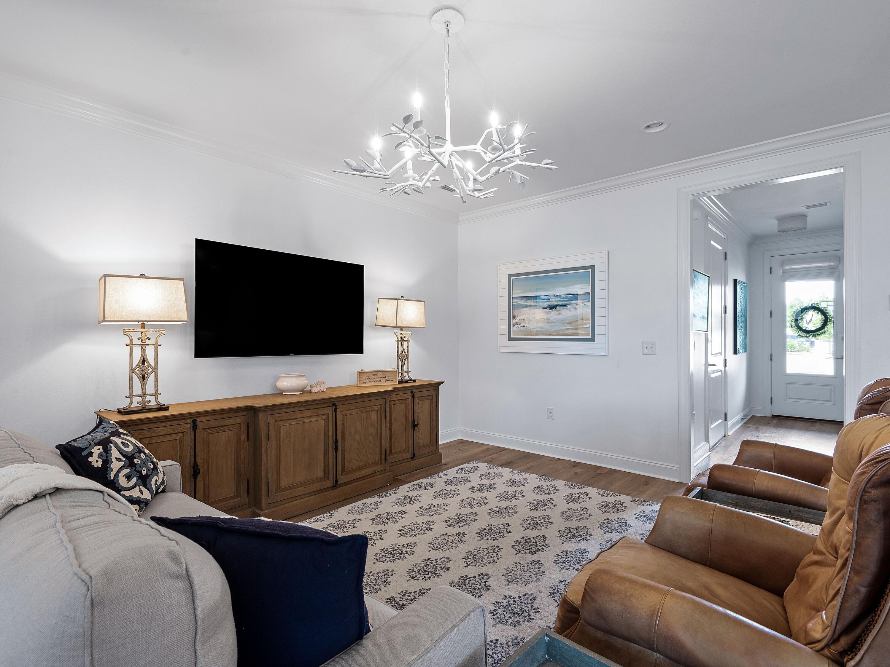 7 Cambium Ct Inlet Beach Inlet Beach, FL 32461 - Photo 4 of 50 a living room with a flat screen tv and a chandelier