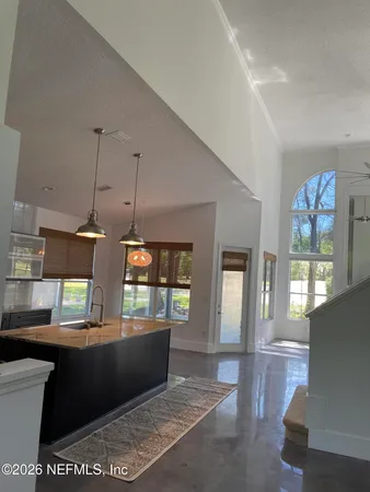 a living room with couches and a dining table with kitchen view