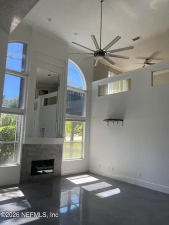a kitchen with stainless steel appliances granite countertop a sink a counter space and a view of living room
