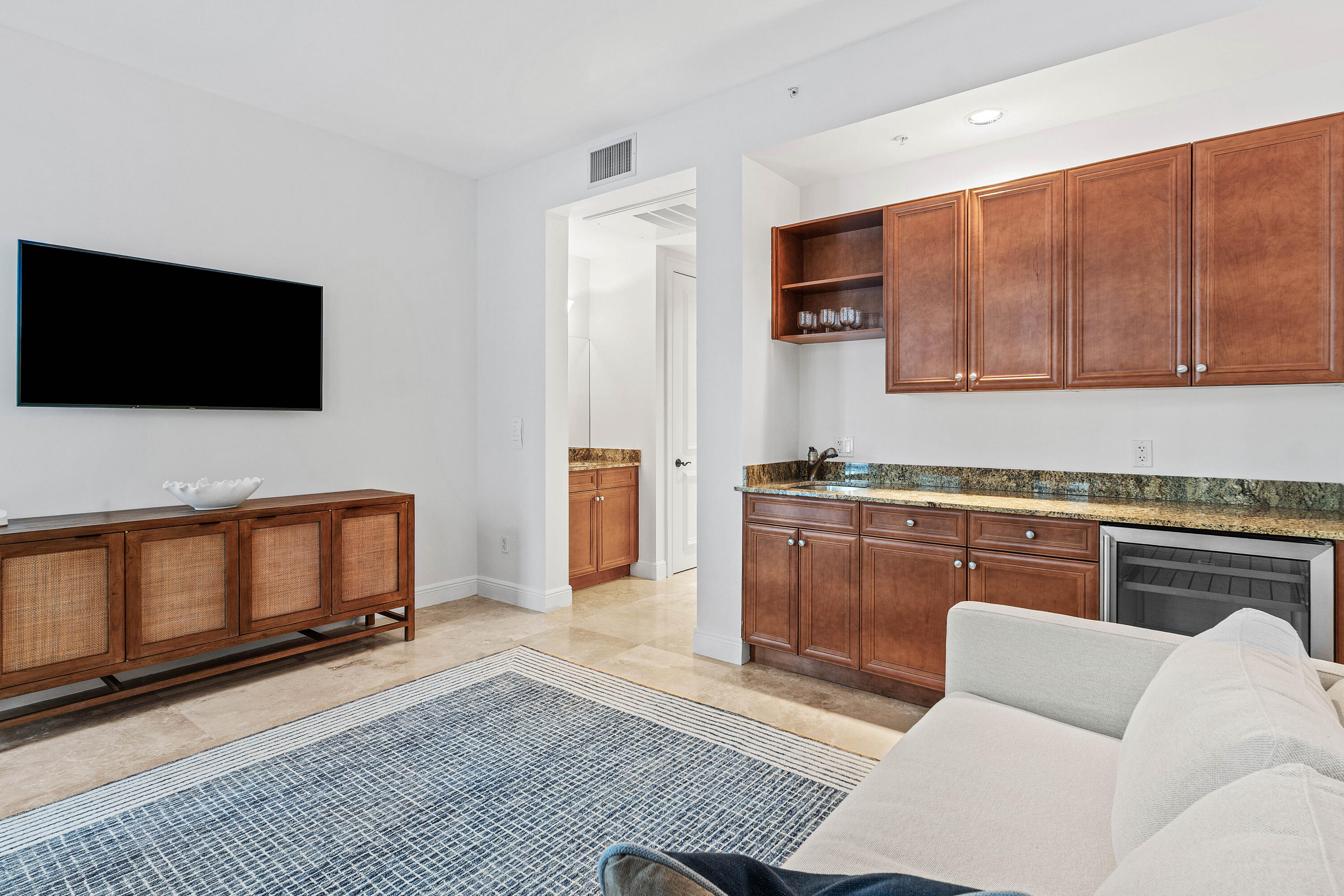 110 Gleason Street, Unit 203 Delray Beach, FL 33483 - Photo 10 of 25 a living room with furniture and a flat screen tv