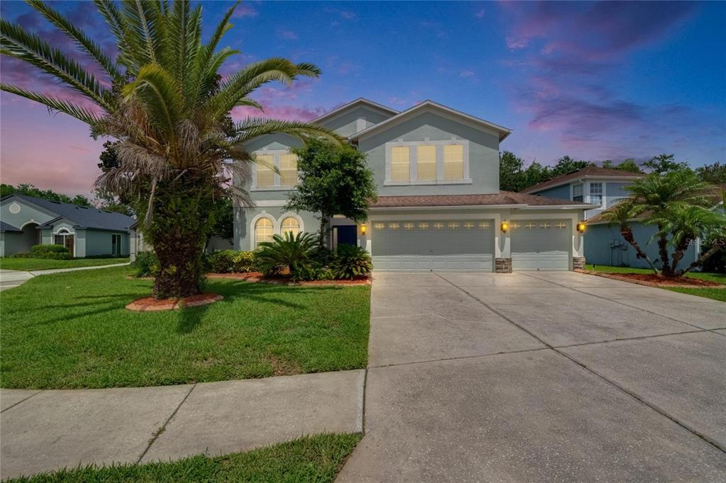 4634 Mapletree Loop Wesley Chapel, FL 33544 - Photo 1 of 1 a front view of a house with garden
