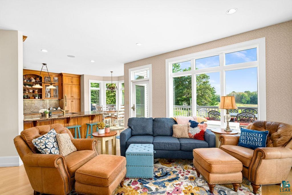 3168 Pioneer Road Barnum, MN 55707 - Photo 19 of 46 This cozy living room, right off of the kitchen has the perfect amount of space to enjoy a morning book or an evening show, or to entertain guests while making dinner. The oversized windows provide natural light and views galore.