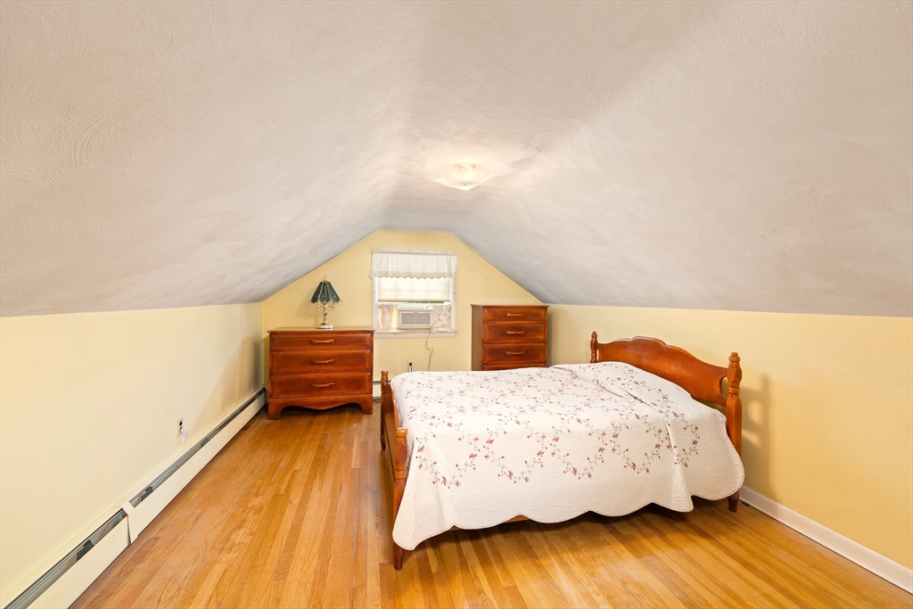 7 Stephen Drive Webster, MA 01570 - Photo 20 of 38 a bedroom with a bed and wooden floor