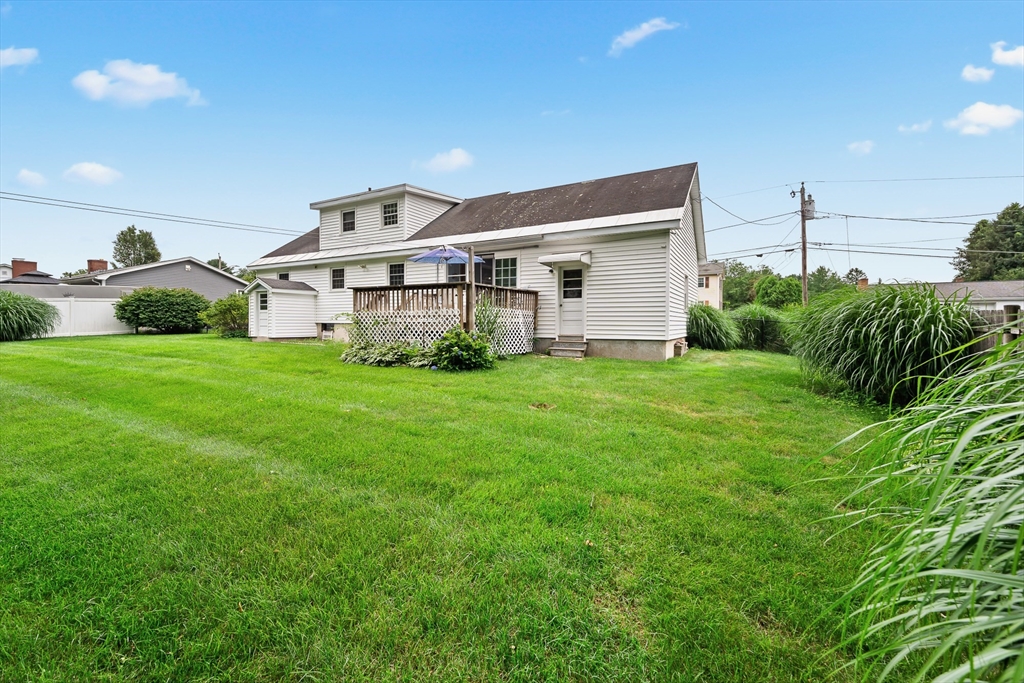 7 Stephen Drive Webster, MA 01570 - Photo 36 of 38 a white house with a small yard and plants