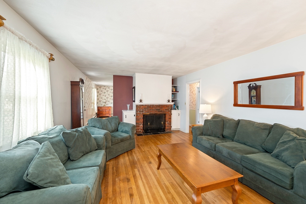 7 Stephen Drive Webster, MA 01570 - Photo 7 of 38 a living room with furniture a fireplace and a large window