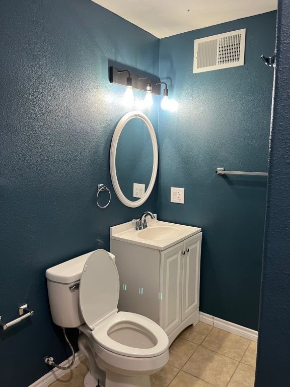 450 Skipper Lane Corpus Christi, TX 78418 - Photo 15 of 26 a bathroom with a toilet a sink and mirror