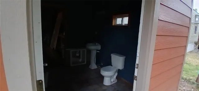 a white toilet sitting next to a bathroom sink