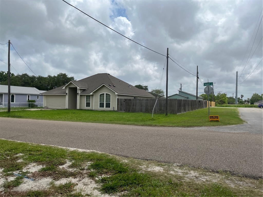 450 Skipper Lane Corpus Christi, TX 78418 - Photo 25 of 26 a view of a house with a big yard and large trees
