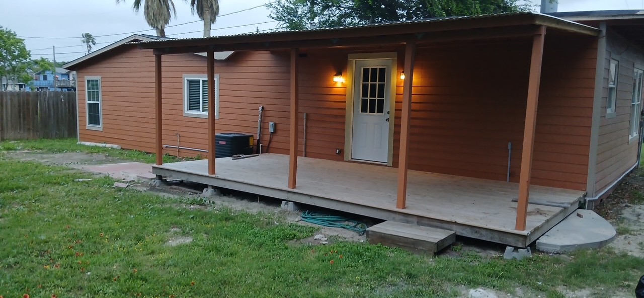 450 Skipper Lane Corpus Christi, TX 78418 - Photo 4 of 26 a backyard of a house with table and chairs