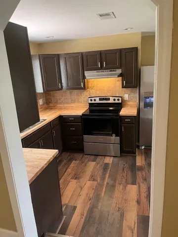 a view of kitchen with cabinets and wooden floor