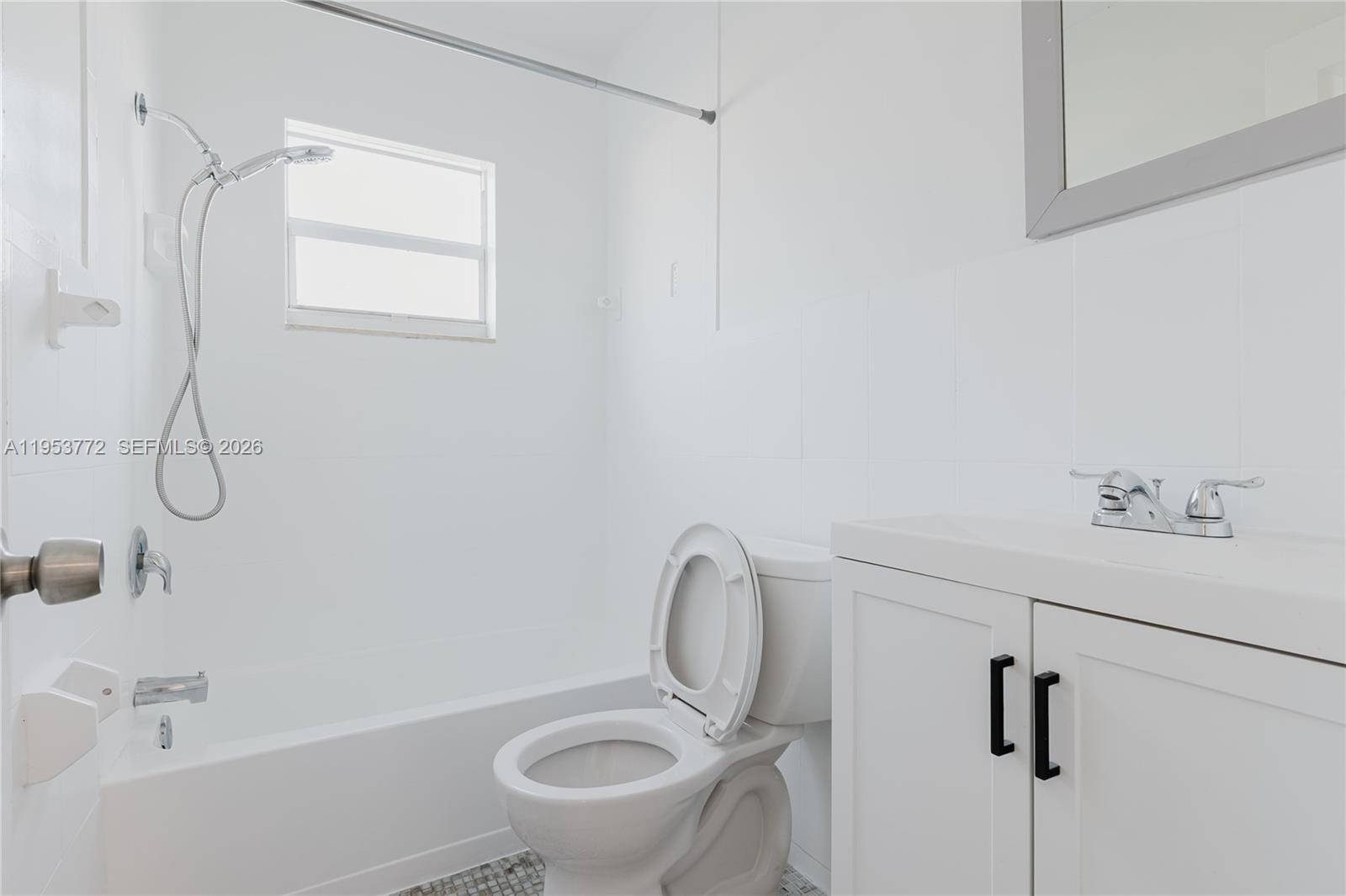 4338 Northwest 24th Avenue Miami, FL 33142 - Photo 20 of 26 a bathroom with a granite countertop sink toilet and shower