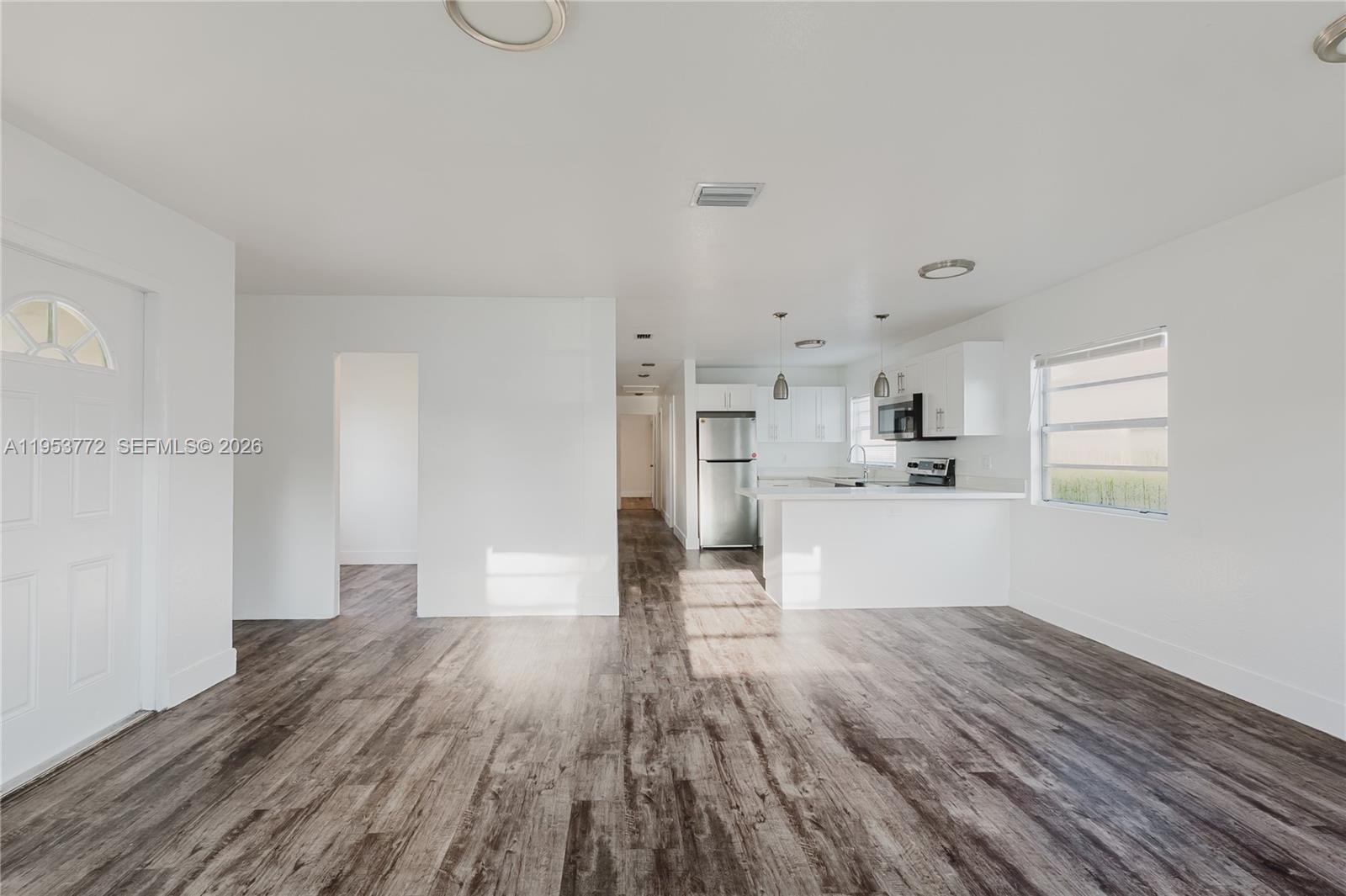 4338 Northwest 24th Avenue Miami, FL 33142 - Photo 3 of 26 a view of kitchen and wooden floor