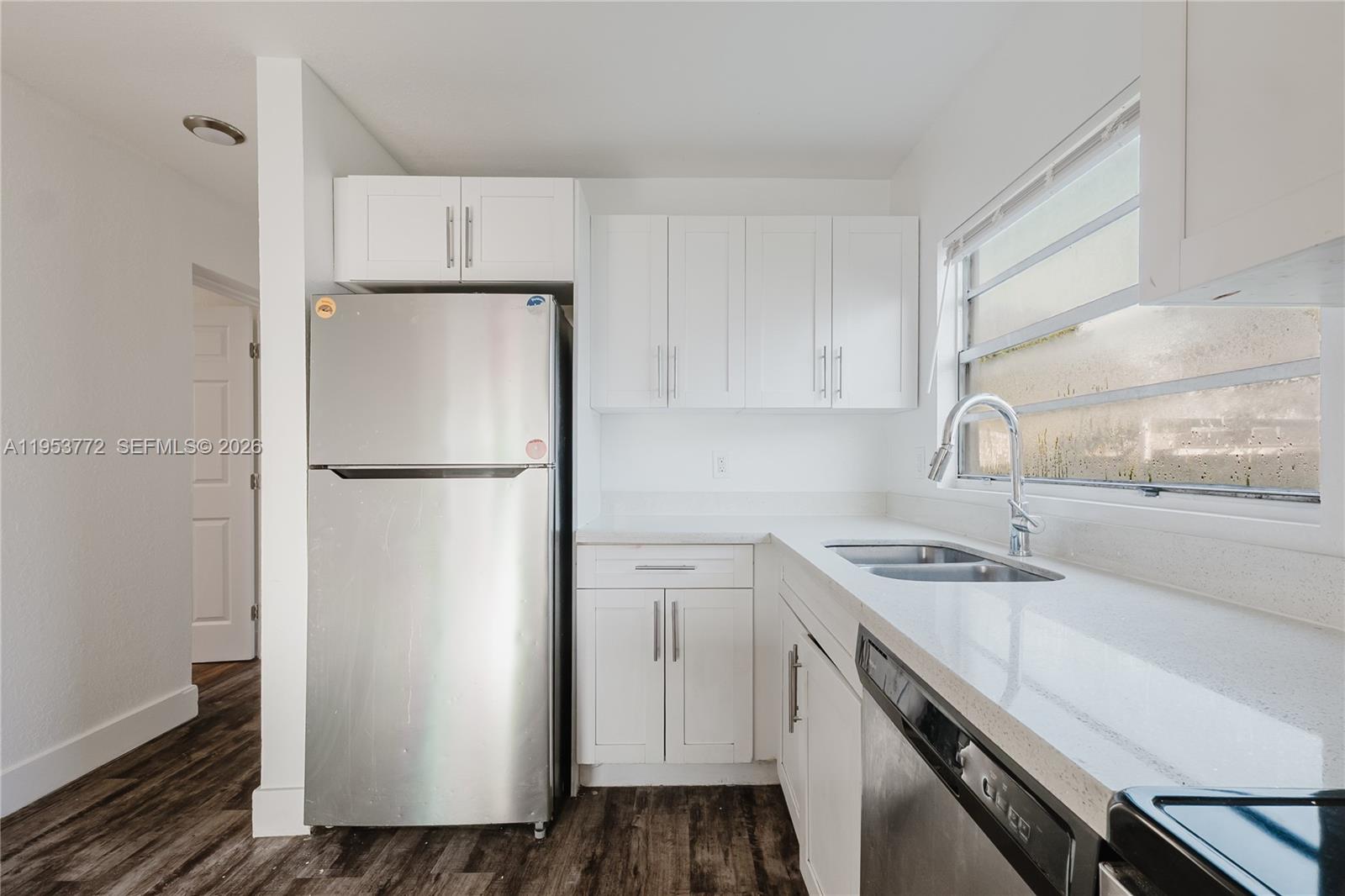 4338 Northwest 24th Avenue Miami, FL 33142 - Photo 5 of 26 a kitchen with a refrigerator sink and stove