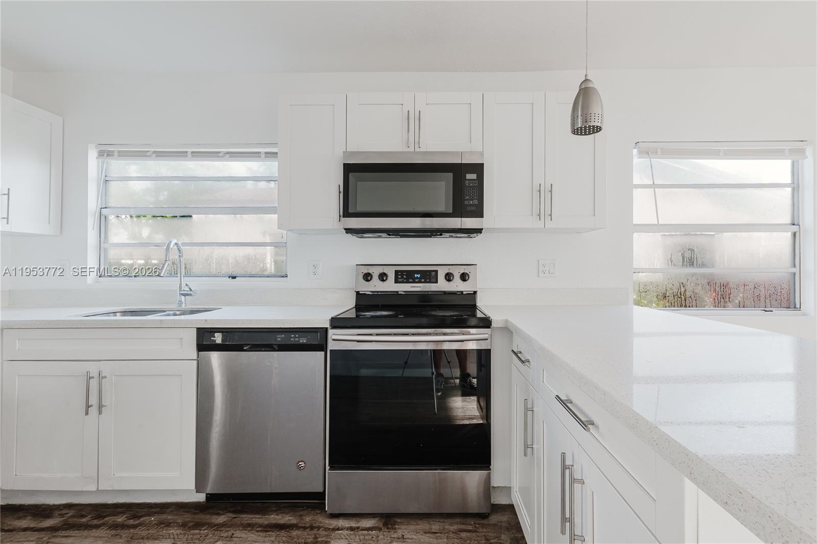 4338 Northwest 24th Avenue Miami, FL 33142 - Photo 7 of 26 a kitchen with stainless steel appliances granite countertop a stove and a sink