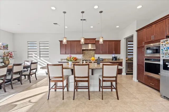 a view of kitchen with kitchen island dining table and chairs