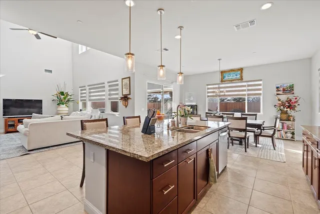 a kitchen with a counter top space a sink appliances and cabinets