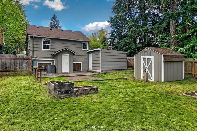 a front view of a house with a yard table and chairs