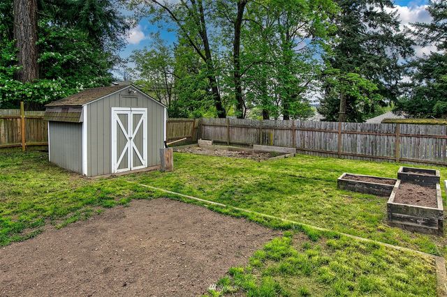 a view of a backyard with a small cabin and a chair