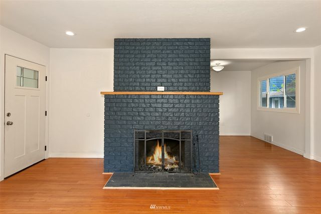 a living room with a fireplace and a wooden floor