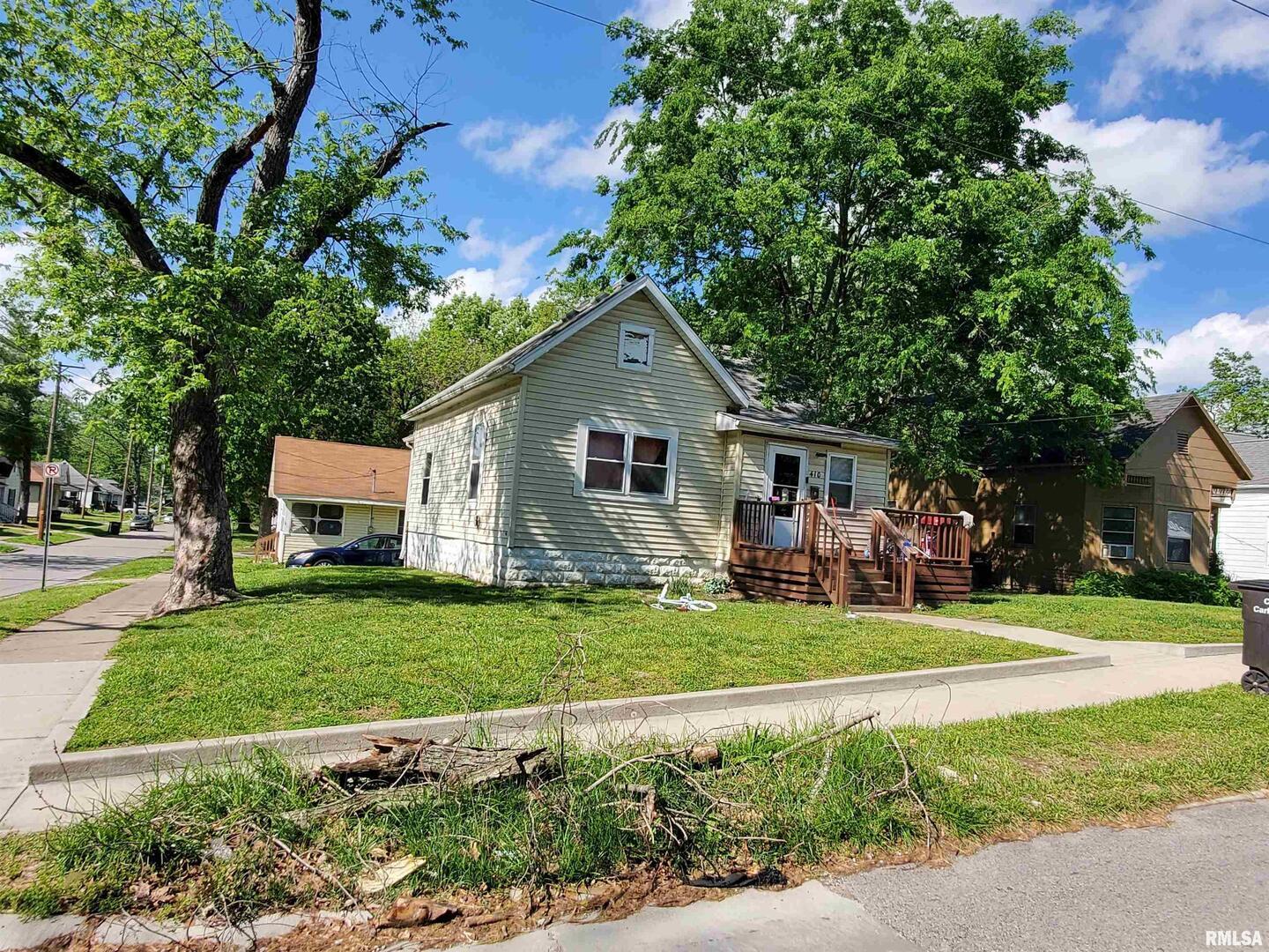 410 West Sycamore Street Carbondale, IL 62901 - Photo 1 of 1 a front view of a house with a garden and trees