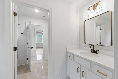 a bathroom with a double vanity sink mirror and