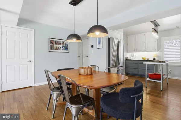 a view of a dining room with furniture and wooden floor