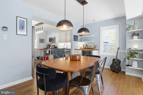 a kitchen with a dining table and chairs