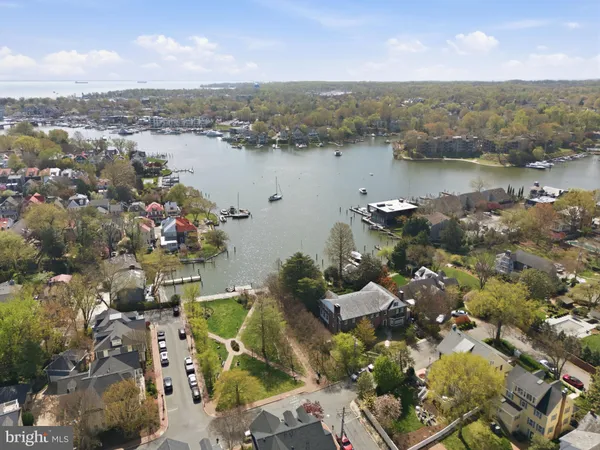 an aerial view of lake and residential houses with outdoor space