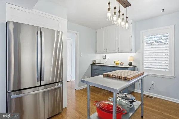 a kitchen with stainless steel appliances granite countertop a refrigerator and a stove top oven